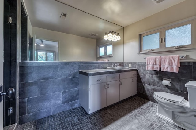 5679 N Van Ness Blvd, Fresno, CA 93711 - full bathroom featuring tile walls, tile patterned flooring, vanity, plenty of natural light, and a wainscoted wall