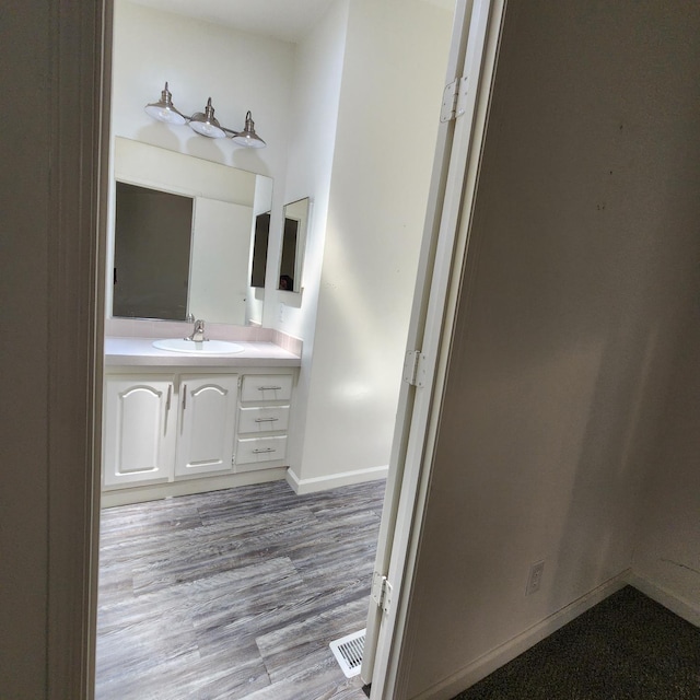12015 E Shaw Ave, Clovis, CA 93619 - bathroom with vanity and wood finished floors