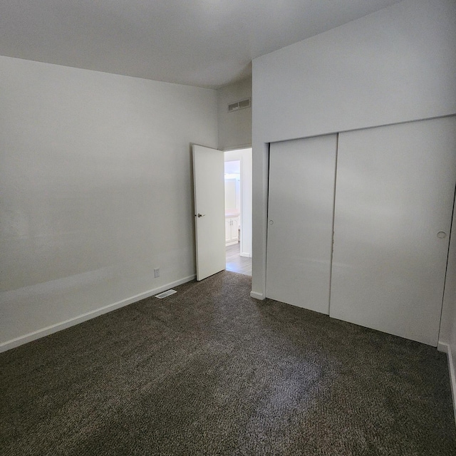 12015 E Shaw Ave, Clovis, CA 93619 - unfurnished bedroom with dark colored carpet and a closet