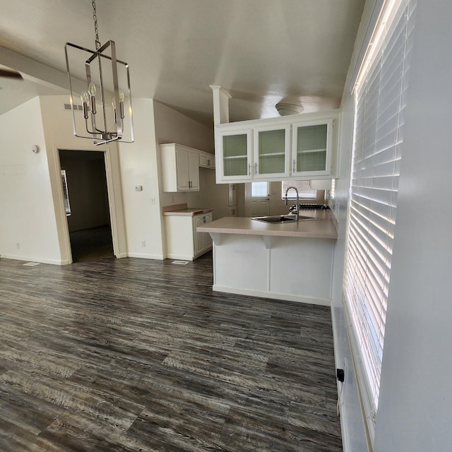 12015 E Shaw Ave, Clovis, CA 93619 - kitchen with lofted ceiling, a peninsula, white cabinetry, glass insert cabinets, and dark wood finished floors
