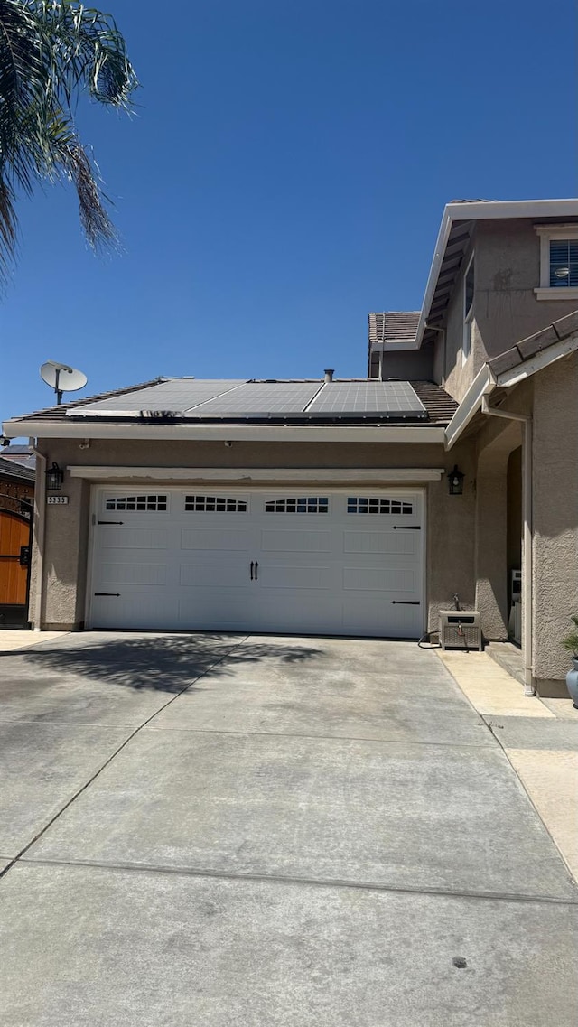 5335 E Hoxie Ave, Fresno, CA 93725 - garage with concrete driveway and solar panels