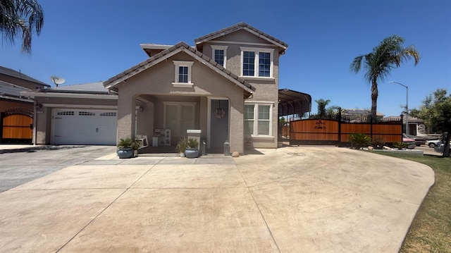 5335 E Hoxie Ave, Fresno, CA 93725 - traditional-style house with stucco siding, a gate, driveway, a carport, and a tiled roof