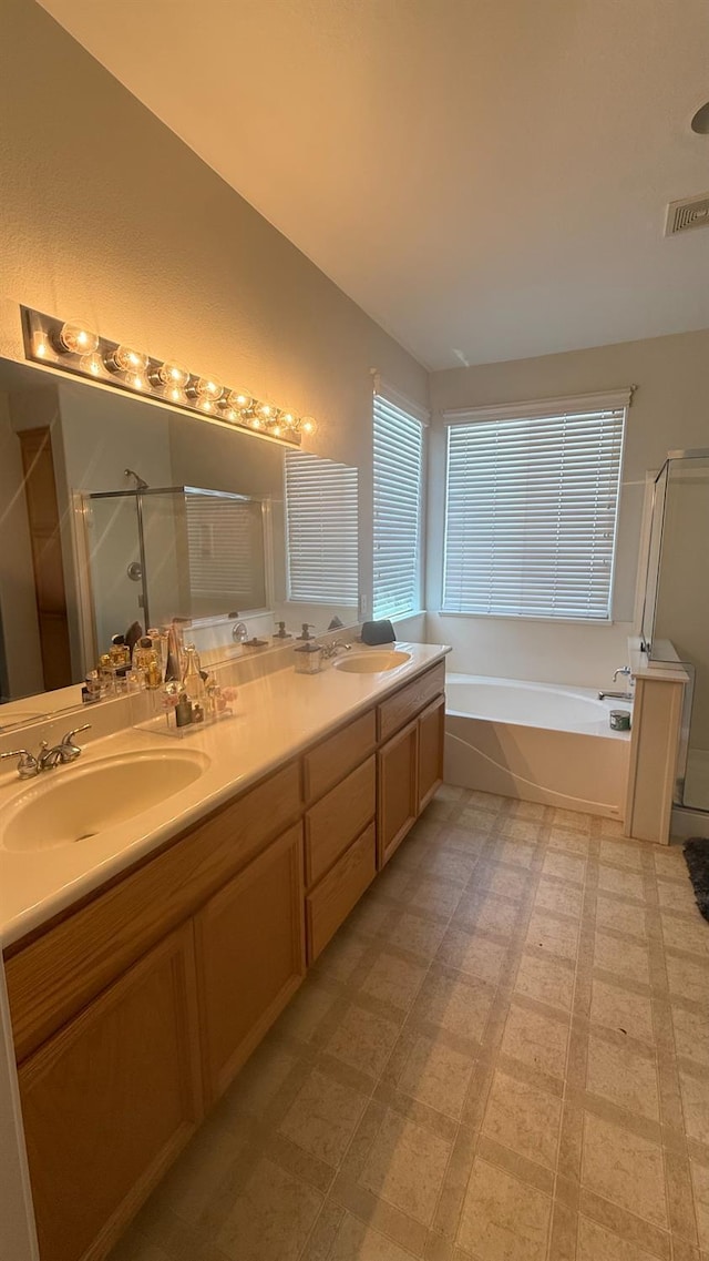 5335 E Hoxie Ave, Fresno, CA 93725 - bathroom with a stall shower, a bath, double vanity, and tile patterned floors