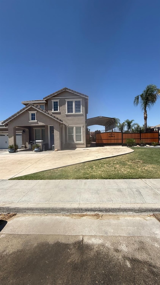 5335 E Hoxie Ave, Fresno, CA 93725 - traditional-style home with concrete driveway, a carport, stucco siding, and a tiled roof