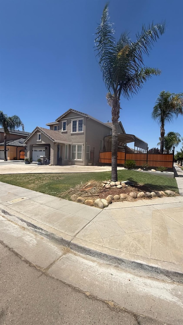5335 E Hoxie Ave, Fresno, CA 93725 - traditional home featuring an attached garage, driveway, and stucco siding