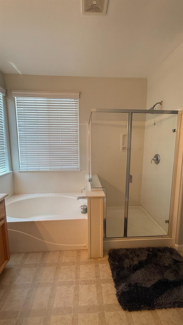 5335 E Hoxie Ave, Fresno, CA 93725 - bathroom featuring a bath, a stall shower, and vanity