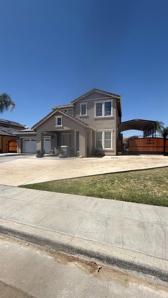 5335 E Hoxie Ave, Fresno, CA 93725 - traditional home with concrete driveway, stucco siding, and a detached carport
