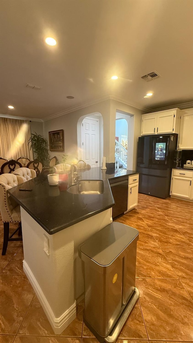 5335 E Hoxie Ave, Fresno, CA 93725 - kitchen with freestanding refrigerator, crown molding, dark countertops, white cabinets, and dishwashing machine