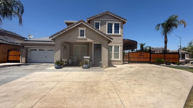 5335 E Hoxie Ave, Fresno, CA 93725 - traditional home with a gate, stucco siding, driveway, a carport, and an attached garage