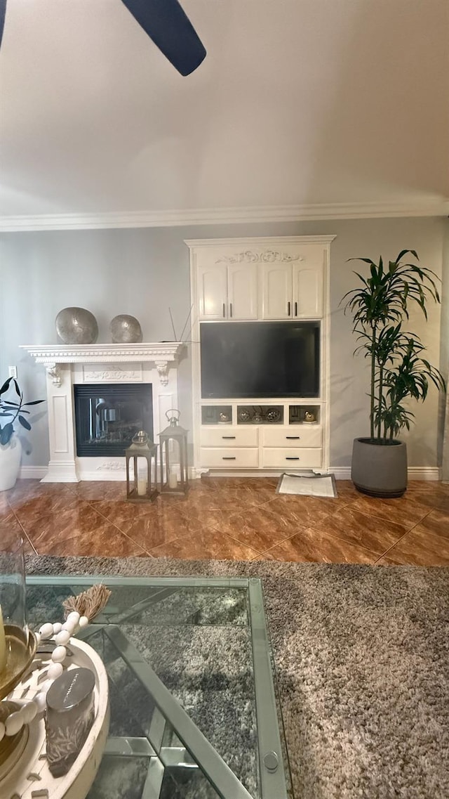 5335 E Hoxie Ave, Fresno, CA 93725 - living room featuring ornamental molding, a glass covered fireplace, and ceiling fan