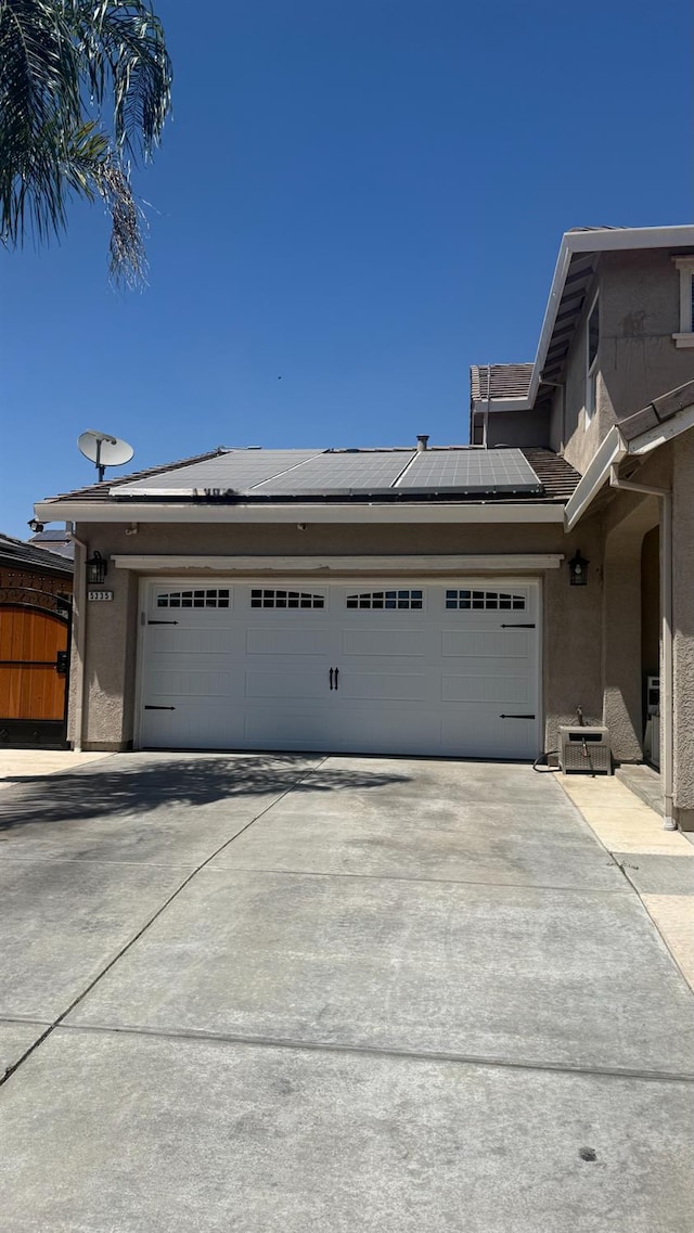 5335 E Hoxie Ave, Fresno, CA 93725 - garage featuring driveway and solar panels