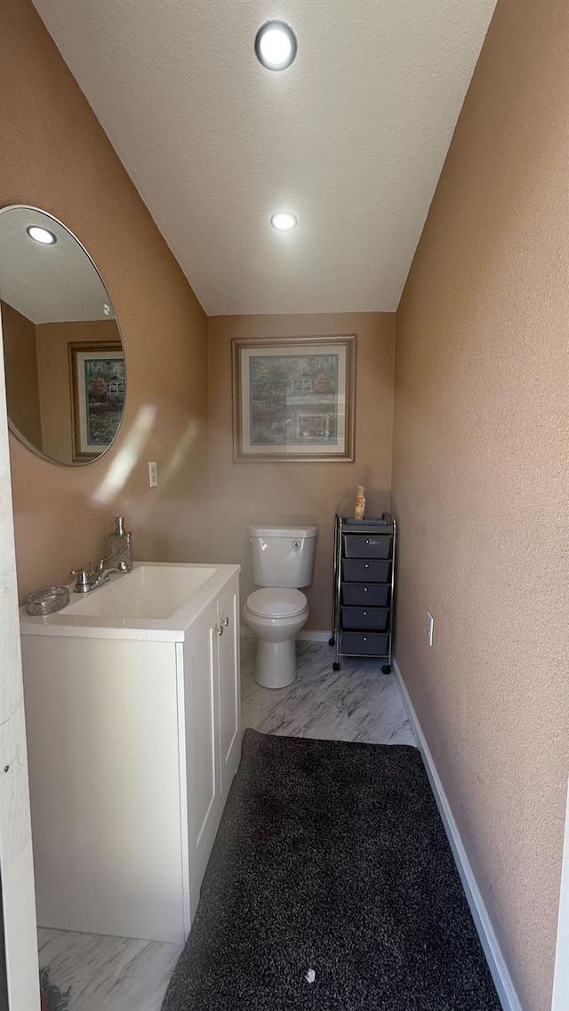 5335 E Hoxie Ave, Fresno, CA 93725 - bathroom with vanity, a textured wall, and recessed lighting