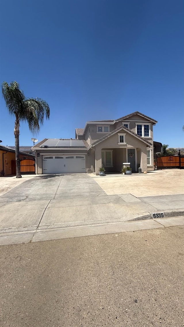 5335 E Hoxie Ave, Fresno, CA 93725 - view of front of property featuring concrete driveway, an attached garage, and stucco siding