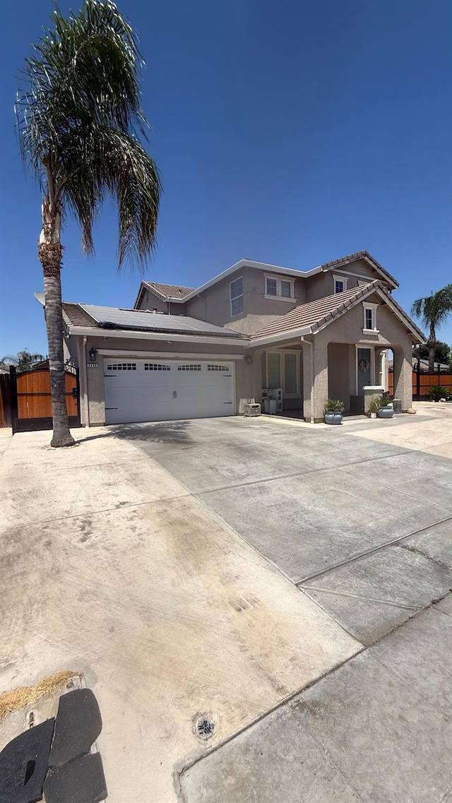 5335 E Hoxie Ave, Fresno, CA 93725 - view of front of property featuring stucco siding, an attached garage, concrete driveway, and a tile roof