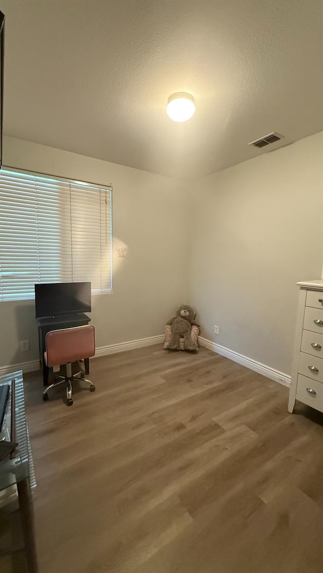 5335 E Hoxie Ave, Fresno, CA 93725 - office featuring wood finished floors and a textured ceiling
