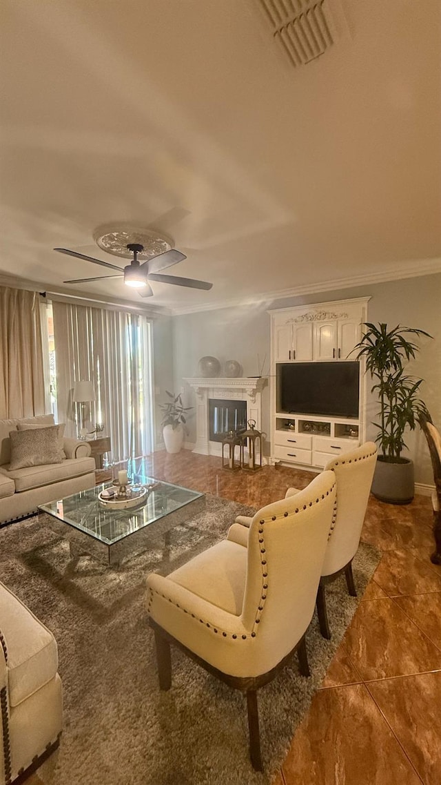 5335 E Hoxie Ave, Fresno, CA 93725 - living room featuring ornamental molding, a fireplace, ceiling fan, and tile patterned flooring