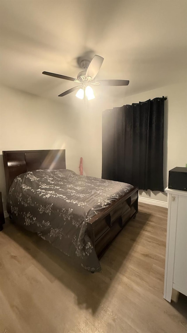 5335 E Hoxie Ave, Fresno, CA 93725 - bedroom with wood finished floors and a ceiling fan