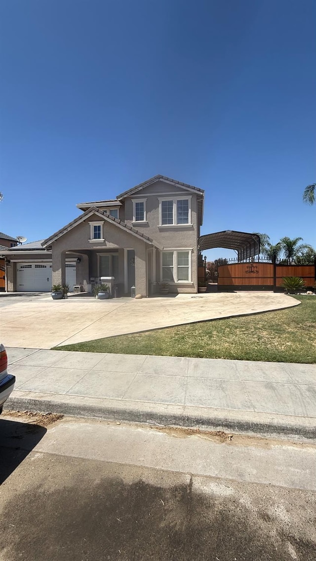 5335 E Hoxie Ave, Fresno, CA 93725 - traditional-style house featuring driveway, stucco siding, a detached carport, and a tile roof