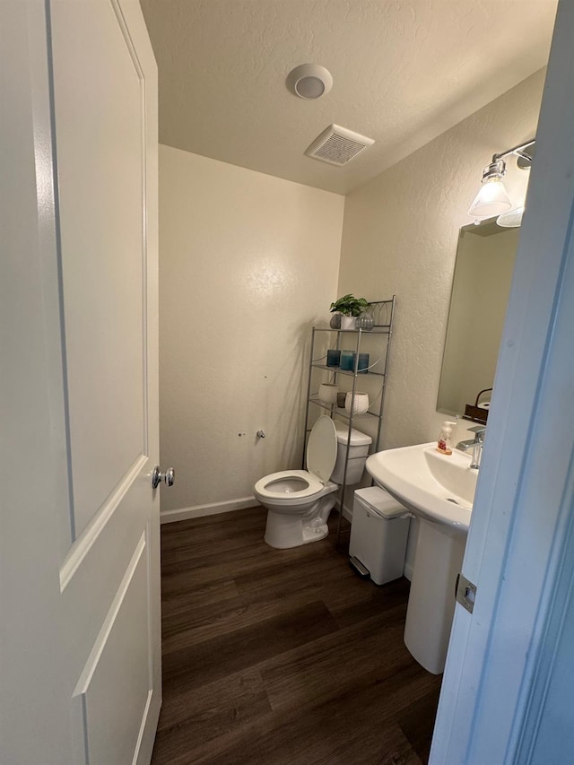 1905 George Ave, Sanger, CA 93657 - half bath with wood finished floors, a textured wall, and a textured ceiling