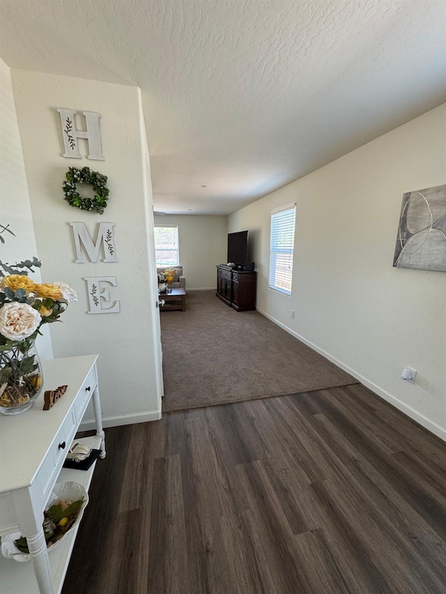 1905 George Ave, Sanger, CA 93657 - corridor with dark wood-style floors and a textured ceiling