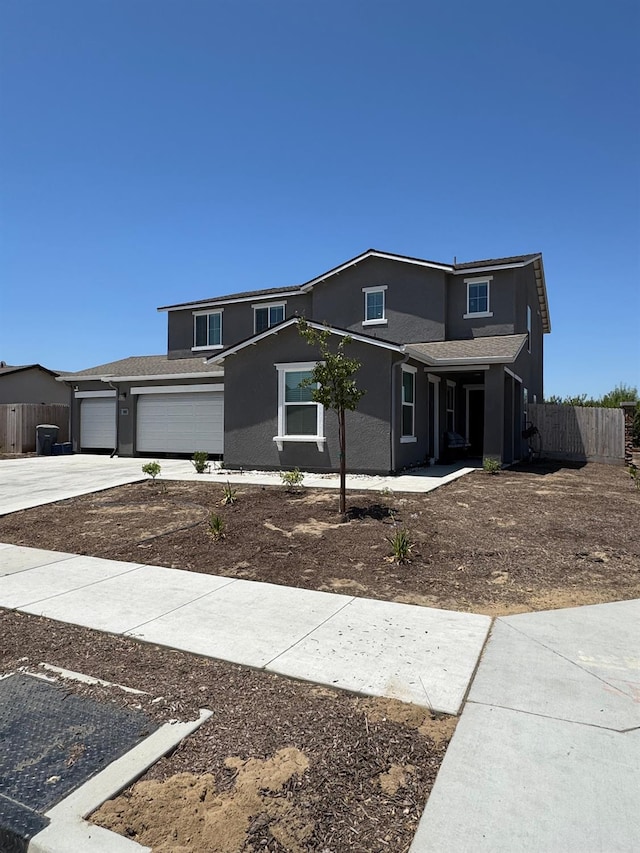 1905 George Ave, Sanger, CA 93657 - traditional-style home featuring stucco siding, concrete driveway, a garage, and covered porch