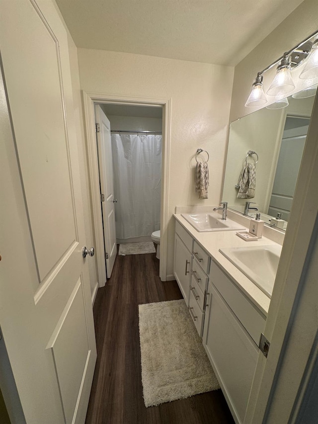1905 George Ave, Sanger, CA 93657 - full bathroom featuring double vanity, wood finished floors, and a shower with curtain