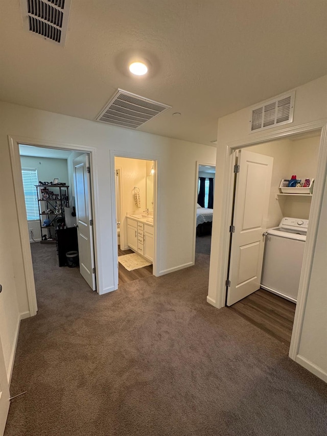 1905 George Ave, Sanger, CA 93657 - hallway featuring washer / dryer and dark colored carpet