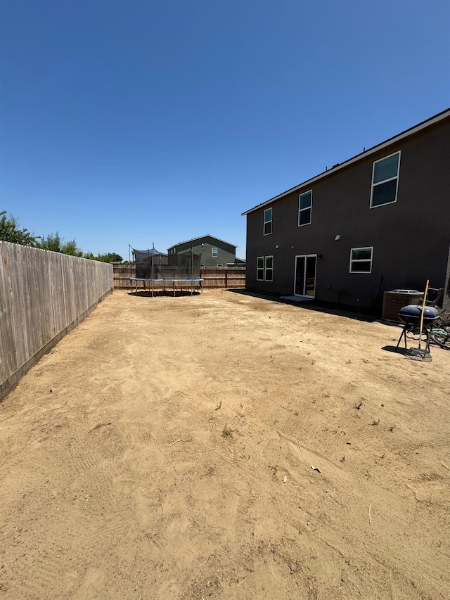 1905 George Ave, Sanger, CA 93657 - fenced backyard featuring a trampoline