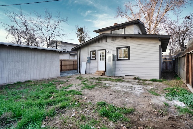 1530 E Home Ave, Fresno, CA 93728 - rear view of property featuring entry steps, a fenced backyard, and a chimney