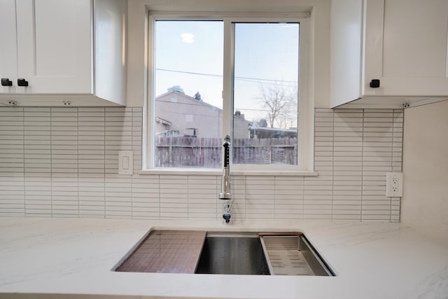1530 E Home Ave, Fresno, CA 93728 - kitchen with backsplash, white cabinetry, plenty of natural light, and light stone counters