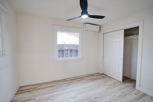1530 E Home Ave, Fresno, CA 93728 - unfurnished bedroom featuring a wall mounted air conditioner, light wood-type flooring, a closet, and a ceiling fan