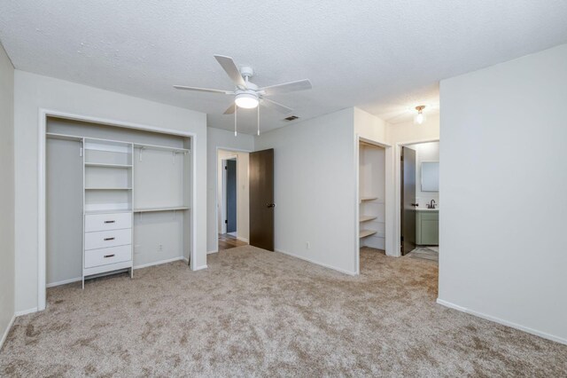 4245 N Manila Ave, Fresno, CA 93727 - unfurnished bedroom with carpet, a closet, ensuite bathroom, a ceiling fan, and a textured ceiling