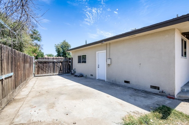 4245 N Manila Ave, Fresno, CA 93727 - view of side of property with crawl space, a patio, and stucco siding