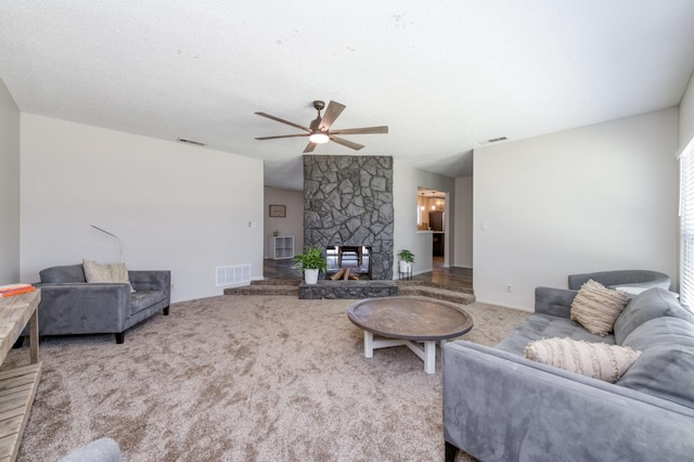 4245 N Manila Ave, Fresno, CA 93727 - carpeted living area featuring a ceiling fan and a fireplace