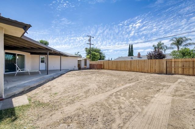 4245 N Manila Ave, Fresno, CA 93727 - fenced backyard featuring a patio and a storage shed