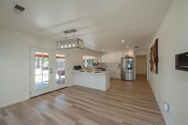 1535 S Homsy Ave, Fresno, CA 93727 - kitchen with smart refrigerator, light countertops, a peninsula, french doors, and white cabinetry