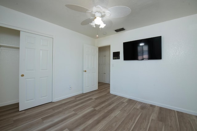1535 S Homsy Ave, Fresno, CA 93727 - unfurnished bedroom with wood finished floors, a closet, and ceiling fan