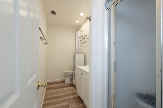 1535 S Homsy Ave, Fresno, CA 93727 - bathroom featuring a shower stall, vanity, wood finished floors, and recessed lighting