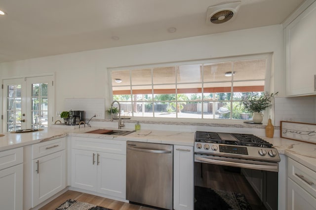 1535 S Homsy Ave, Fresno, CA 93727 - kitchen with appliances with stainless steel finishes, healthy amount of natural light, and backsplash
