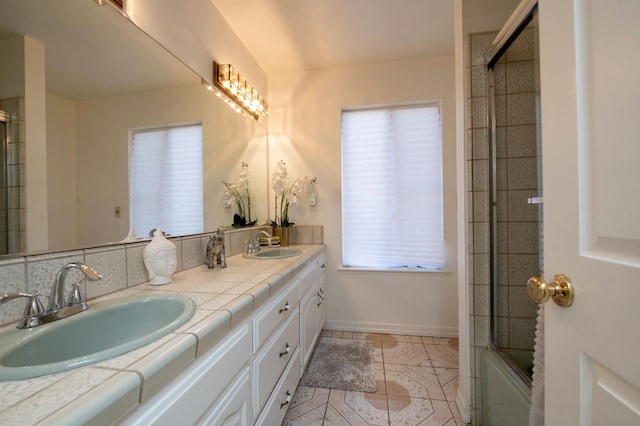 1535 S Homsy Ave, Fresno, CA 93727 - full bathroom featuring double vanity, tile patterned flooring, and shower / bath combination with glass door