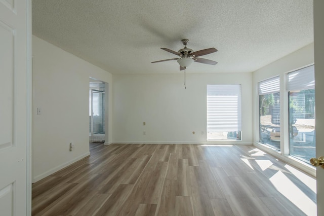 1535 S Homsy Ave, Fresno, CA 93727 - empty room featuring a ceiling fan, a textured ceiling, and light wood-style floors