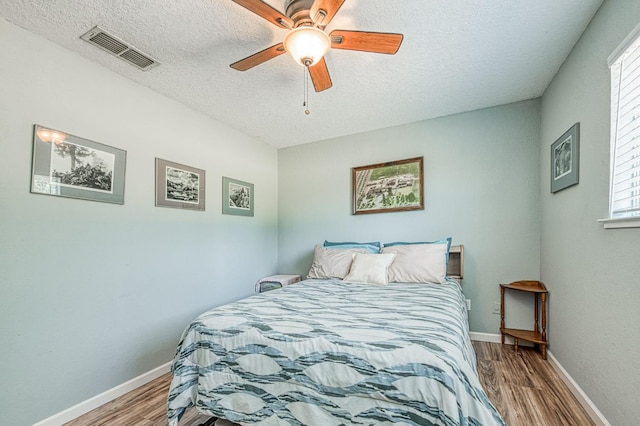 5400 Amber Ave, Clovis, CA 93619 - bedroom featuring wood finished floors, a textured ceiling, and a ceiling fan
