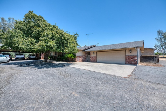 5400 Amber Ave, Clovis, CA 93619 - view of front of home with a garage, brick siding, and driveway