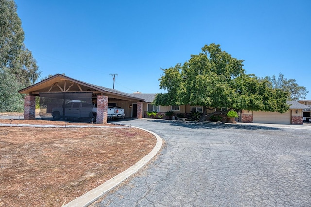 5400 Amber Ave, Clovis, CA 93619 - view of front facade with brick siding, a carport, and asphalt driveway