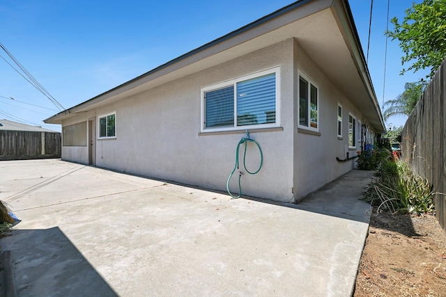 2044 Mayfair Dr W, Fresno, CA 93703 - view of side of property featuring a patio area and stucco siding