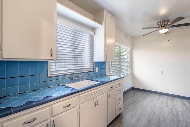 2044 Mayfair Dr W, Fresno, CA 93703 - kitchen featuring tile countertops, ceiling fan, white cabinets, and wood finished floors