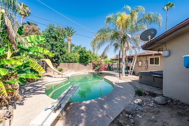 4625 E Princeton Ave, Fresno, CA 93703 - view of swimming pool featuring a hot tub, a fenced backyard, a water slide, a patio area, and a diving board