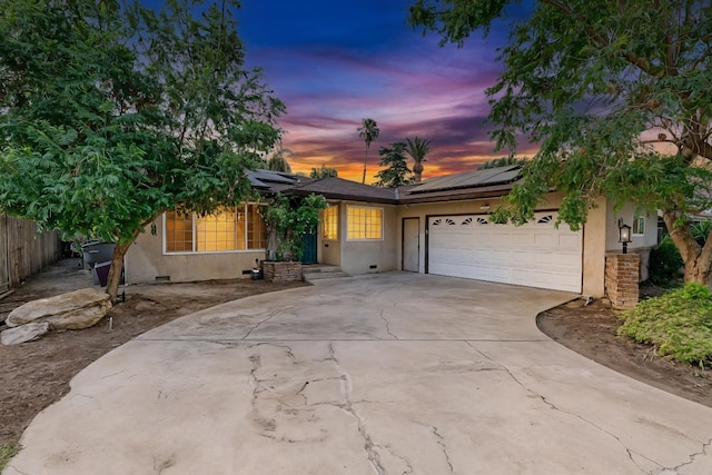 4625 E Princeton Ave, Fresno, CA 93703 - single story home featuring stucco siding, concrete driveway, a garage, and roof mounted solar panels