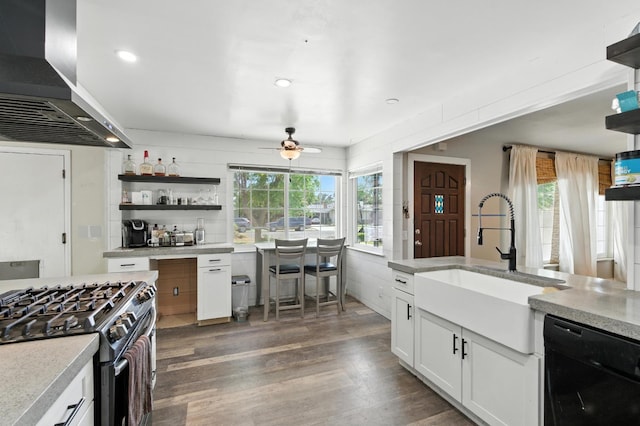 4625 E Princeton Ave, Fresno, CA 93703 - kitchen with black dishwasher, range hood, stainless steel range with gas stovetop, ceiling fan, and light countertops