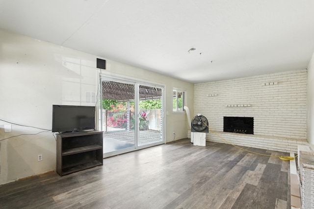 4625 E Princeton Ave, Fresno, CA 93703 - unfurnished living room featuring wood finished floors and a brick fireplace